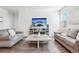 Cozy living room with comfortable sofas, a large screen TV, and stylish decor for a relaxing atmosphere at 7414 E 158Th Pl, Thornton, CO 80602