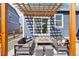 Comfortable outdoor living space featuring modern furniture and a wooden pergola at 7414 E 158Th Pl, Thornton, CO 80602