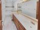 Well-lit bathroom featuring double sinks, a large mirror, and tile flooring at 584 W Prestwick Way, Castle Rock, CO 80104