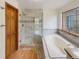 Spa-like bathroom with glass enclosed shower, soaking tub, and elegant tile work at 584 W Prestwick Way, Castle Rock, CO 80104