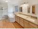 Primary bathroom featuring double vanities, soaking tub, and tiled glass-enclosed shower at 584 W Prestwick Way, Castle Rock, CO 80104