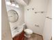 Cozy bathroom featuring a round mirror, white sink, and neutral tile flooring at 584 W Prestwick Way, Castle Rock, CO 80104