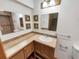 Bathroom featuring corner vanity with tile countertop and decorative framed mirror at 584 W Prestwick Way, Castle Rock, CO 80104