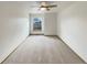 Empty bedroom showcasing neutral carpet, a ceiling fan, and a window with neighborhood views at 584 W Prestwick Way, Castle Rock, CO 80104
