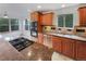 Well-lit kitchen featuring granite countertops, wood cabinetry, and stainless steel appliances at 584 W Prestwick Way, Castle Rock, CO 80104