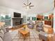 Bright living room with a stone fireplace, hardwood floors, and seamless access to the kitchen at 584 W Prestwick Way, Castle Rock, CO 80104