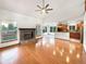 Bright living room with a stone fireplace, hardwood floors, and seamless access to the kitchen at 584 W Prestwick Way, Castle Rock, CO 80104