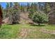 Scenic backyard featuring lush greenery and natural surroundings in a peaceful setting at 11080 S Deer Creek Rd, Littleton, CO 80127