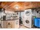 Basement area features a kitchenette, countertop seating, laundry area, and a stacked washer and dryer at 11080 S Deer Creek Rd, Littleton, CO 80127