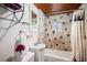 Cozy bathroom with a combination shower and tub, and decorative tiling at 11080 S Deer Creek Rd, Littleton, CO 80127
