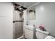 Bathroom featuring a shower, small sink and vanity, toilet, and accent mirror at 11080 S Deer Creek Rd, Littleton, CO 80127