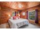 Comfortable bedroom with warm wood accents, soft lighting, and ample natural light at 11080 S Deer Creek Rd, Littleton, CO 80127