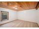 Cozy bedroom with carpeted floors, natural light streaming through the window and wood paneled ceiling at 11080 S Deer Creek Rd, Littleton, CO 80127