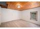 Neutral bedroom with carpeted floors, and natural light streaming through the basement window at 11080 S Deer Creek Rd, Littleton, CO 80127