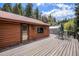 Expansive wooden deck perfect for entertaining, with views of the surrounding trees at 11080 S Deer Creek Rd, Littleton, CO 80127