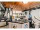 Close up of basement kitchenette featuring a black tiled countertop and backsplash with natural light at 11080 S Deer Creek Rd, Littleton, CO 80127