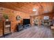 Cozy living room with wood-paneled walls, fireplace, and modern entertainment setup at 11080 S Deer Creek Rd, Littleton, CO 80127