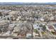 Expansive aerial view of neighborhood homes and streets, with mountain views in the background at 3064 S Cherokee St, Englewood, CO 80110