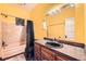 Bathroom features a single sink vanity, toilet, shower and tub at 3064 S Cherokee St, Englewood, CO 80110