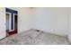 Vacant bedroom with access to laundry through open door and a gray carpet at 3064 S Cherokee St, Englewood, CO 80110