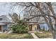Charming home with a well-maintained lawn, mature trees, and inviting front porch at 3064 S Cherokee St, Englewood, CO 80110