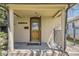 Charming front porch featuring a vintage front door, classic columns, and wrought iron details at 3064 S Cherokee St, Englewood, CO 80110