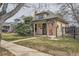 Charming single-story home featuring a cozy front porch, well-maintained lawn, and an American flag at 3064 S Cherokee St, Englewood, CO 80110