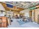 Large garage with exposed wood beams and unfinished drywall and storage at 3064 S Cherokee St, Englewood, CO 80110