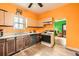 Bright kitchen features a gas range, stainless steel dishwasher, and wood cabinets at 3064 S Cherokee St, Englewood, CO 80110