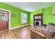 Bright living room with wood floors, decorative fireplace, and classic details near front entrance at 3064 S Cherokee St, Englewood, CO 80110