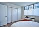 Bright bedroom with ample closet space, a large window, and warm, inviting decor at 830 N Sherman St # 205, Denver, CO 80203