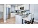 Modern kitchen with stainless steel appliances, subway tile backsplash, and breakfast bar at 830 N Sherman St # 205, Denver, CO 80203