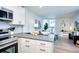 Kitchen and living space features white cabinetry and a stainless steel oven and microwave at 830 N Sherman St # 205, Denver, CO 80203