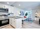 Bright living room with a kitchen, stainless steel appliances, and balcony access at 830 N Sherman St # 205, Denver, CO 80203