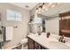 Bright bathroom featuring a double sink vanity, white countertops and tile flooring at 1157 Mircos St, Erie, CO 80516