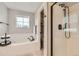 Bathroom featuring a soaking tub, a separate shower, modern fixtures, and neutral color palette at 1157 Mircos St, Erie, CO 80516