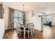 Cozy dining room with modern chandelier, hardwood floors, and elegant curtains at 1157 Mircos St, Erie, CO 80516