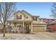 Charming two-story home featuring red shutters, a covered front porch, and a two-car attached garage at 1157 Mircos St, Erie, CO 80516