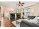 Spacious living room featuring a stone fireplace, hardwood floors, and modern decor at 1157 Mircos St, Erie, CO 80516