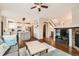 Open-concept living room leading to a kitchen and staircase, featuring a fireplace and hardwood floors at 1157 Mircos St, Erie, CO 80516