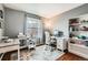 Functional home office space with a desk, shelving, a comfortable chair, and natural light at 1157 Mircos St, Erie, CO 80516