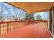 Inviting back porch features a red wooden deck and offers a cozy space for outdoor relaxation and enjoyment at 9693 W Euclid Dr, Littleton, CO 80123