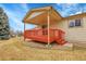 Exterior of house with red wood deck and small yard at 9693 W Euclid Dr, Littleton, CO 80123