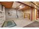 Unfinished basement with shelving, concrete walls, and exposed ceiling at 9693 W Euclid Dr, Littleton, CO 80123