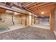 Unfinished basement with concrete walls, open ceiling and carpet tiles partially installed at 9693 W Euclid Dr, Littleton, CO 80123