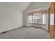 Spacious bedroom with neutral carpet, bay windows, and ample natural light at 9693 W Euclid Dr, Littleton, CO 80123