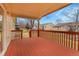 Wood deck with red railings and a covered area with ample seating space at 9693 W Euclid Dr, Littleton, CO 80123