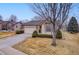 Charming single-story home with a well-maintained lawn, complemented by a two-car garage and tasteful landscaping at 9693 W Euclid Dr, Littleton, CO 80123