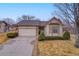 Attractive single-story home with a well-maintained lawn, complemented by a two-car garage and tasteful landscaping at 9693 W Euclid Dr, Littleton, CO 80123