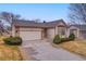 Appealing single-story home with a well-maintained lawn, complemented by a two-car garage and manicured landscaping at 9693 W Euclid Dr, Littleton, CO 80123